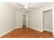 Bedroom featuring hardwood floors, neutral paint, a ceiling fan, and a closet for ample storage at 656 Lake Charm Dr, Oviedo, FL 32765