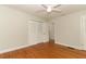 Bedroom featuring hardwood floors, neutral walls, a ceiling fan, and closet for storage at 656 Lake Charm Dr, Oviedo, FL 32765
