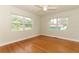 Inviting bedroom with hardwood floors and large windows offering natural light and outdoor views at 656 Lake Charm Dr, Oviedo, FL 32765