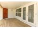 Covered porch featuring wood flooring, exterior door and glass paneled french doors at 656 Lake Charm Dr, Oviedo, FL 32765
