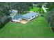 Aerial view of a charming home with a spacious backyard, a new deck, and lush surrounding greenery at 656 Lake Charm Dr, Oviedo, FL 32765