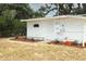 White building exterior with manicured landscaping and a well-maintained yard at 656 Lake Charm Dr, Oviedo, FL 32765