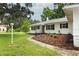 Landscaped front yard leads to this recently renovated home with fresh paint and new walkway at 656 Lake Charm Dr, Oviedo, FL 32765