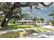Charming single-story home featuring manicured lawn, mature oak trees and freshly painted exterior at 656 Lake Charm Dr, Oviedo, FL 32765