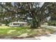 Mature oak tree with a wide canopy shades the home's front yard at 656 Lake Charm Dr, Oviedo, FL 32765