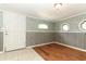 Unique interior space with nautical wallpaper, wainscoting, and a mix of tiled and wood floors at 656 Lake Charm Dr, Oviedo, FL 32765