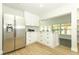 Modern kitchen boasts stainless steel appliances and access to additional bright room at 656 Lake Charm Dr, Oviedo, FL 32765