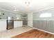 Kitchenette featuring stainless fridge, sink, white cabinets and a mix of tiled and wood floors at 656 Lake Charm Dr, Oviedo, FL 32765