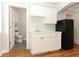 Cozy kitchenette featuring white cabinets, marbled countertops, stainless steel sink and black refrigerator at 656 Lake Charm Dr, Oviedo, FL 32765