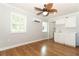 Open-concept living room and kitchenette features wood floors, ceiling fans and ample natural light at 656 Lake Charm Dr, Oviedo, FL 32765