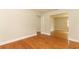 Open living room with beautiful hardwood floors connecting multiple living spaces at 656 Lake Charm Dr, Oviedo, FL 32765