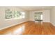 Bright living room featuring hardwood floors and large windows offering natural light at 656 Lake Charm Dr, Oviedo, FL 32765