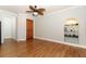 Open-concept living room boasts wood floors, decorative niches, ceiling fan and ample natural light at 656 Lake Charm Dr, Oviedo, FL 32765