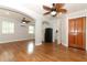 Open-concept living room featuring wood floors, ceiling fans and ample natural light at 656 Lake Charm Dr, Oviedo, FL 32765