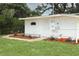 Exterior of a charming white shed with a well-maintained lawn at 656 Lake Charm Dr, Oviedo, FL 32765