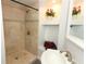 Modern shower featuring beige tile, a built-in niche with decorative items, and updated fixtures at 656 Lake Charm Dr, Oviedo, FL 32765