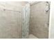 Tiled shower with Eiffel Tower curtain and chrome shower head and handle at 656 Lake Charm Dr, Oviedo, FL 32765