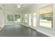 Sun room featuring large windows, French doors, and a ceiling fan at 656 Lake Charm Dr, Oviedo, FL 32765