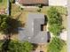 Overhead picture of house and its surroundings featuring a durable roof and neat lawns at 672 Reindeer Dr, Kissimmee, FL 34759