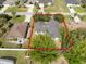 Aerial view shows the property's placement amidst green trees in an established neighborhood at 672 Reindeer Dr, Kissimmee, FL 34759