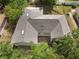 High angle aerial shot of the house with a durable roof and mature trees at 672 Reindeer Dr, Kissimmee, FL 34759