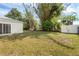 Spacious backyard with well-maintained lawn and lush, mature trees providing shade at 672 Reindeer Dr, Kissimmee, FL 34759