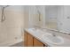 Well-lit bathroom featuring double sinks, a large mirror, and a shower-tub combination at 672 Reindeer Dr, Kissimmee, FL 34759