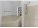 Clean bathroom showcasing a corner tub, step-in shower, and ample natural light at 672 Reindeer Dr, Kissimmee, FL 34759