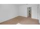 Bright bedroom with carpet flooring, a door to the bathroom and plenty of space for furniture at 672 Reindeer Dr, Kissimmee, FL 34759