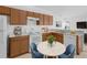 Cozy eat-in kitchen with white appliances, wooden cabinets, and tile flooring at 672 Reindeer Dr, Kissimmee, FL 34759