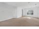 Bright, open living room with neutral carpet, white walls, and ample natural light at 672 Reindeer Dr, Kissimmee, FL 34759