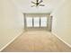 Bedroom featuring neutral walls, plush carpeting, and multiple windows for ample natural light at 7054 Cadiz Blvd, Orlando, FL 32819