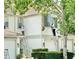 A view of the exterior facade of the home, showing landscapers on ladders doing exterior work at 7054 Cadiz Blvd, Orlando, FL 32819