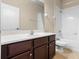 Bright bathroom featuring a vanity with white countertop, dark wood cabinets, and a combined shower and tub at 7201 Halton Ct, Windermere, FL 34786