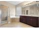 Elegant bathroom with double vanity, corner tub, and glass-enclosed shower at 7201 Halton Ct, Windermere, FL 34786