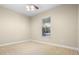 This bedroom features neutral carpet and paint plus a ceiling fan and natural light at 7201 Halton Ct, Windermere, FL 34786