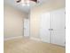 The bedroom features neutral walls, carpet, ceiling fan, and a large closet for storage at 7201 Halton Ct, Windermere, FL 34786