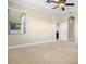 Inviting bedroom with a ceiling fan, neutral carpet and easy access to a closet and en-suite bathroom at 7201 Halton Ct, Windermere, FL 34786