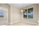 Cozy dining area features bright light from window with decorative chandelier and tile flooring at 7201 Halton Ct, Windermere, FL 34786