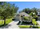 Charming one-story home with a two-car garage, mature trees, and lush landscaping for curb appeal at 7201 Halton Ct, Windermere, FL 34786