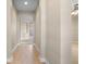 Inviting hallway with tile flooring, arched doorways, and neutral paint, leading to other living spaces at 7201 Halton Ct, Windermere, FL 34786