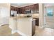 Well-appointed kitchen with a center island, stainless steel refrigerator, and classic wood cabinetry at 7201 Halton Ct, Windermere, FL 34786