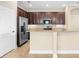 Modern kitchen with stainless steel appliances, granite countertops, and rich, dark cabinets at 7201 Halton Ct, Windermere, FL 34786