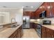 Updated kitchen featuring stainless steel appliances, granite countertops, and wood cabinetry at 7201 Halton Ct, Windermere, FL 34786