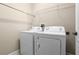 Laundry room with white washer and dryer, wire shelving, and neutral walls at 7201 Halton Ct, Windermere, FL 34786