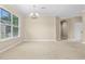 Bright living room featuring plush carpeting, ample natural light from large windows, and elegant overhead lighting at 7201 Halton Ct, Windermere, FL 34786