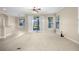 Bright, open living room featuring neutral tones, a ceiling fan, and sliding glass doors to the outside at 7201 Halton Ct, Windermere, FL 34786
