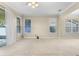 Open-concept living room with a ceiling fan and large windows that let in ample natural light at 7201 Halton Ct, Windermere, FL 34786