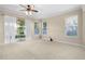 Light and airy living room with lots of natural light from multiple windows and sliding glass doors at 7201 Halton Ct, Windermere, FL 34786