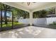 Screened porch with views of a fenced backyard and lush green trees at 7201 Halton Ct, Windermere, FL 34786